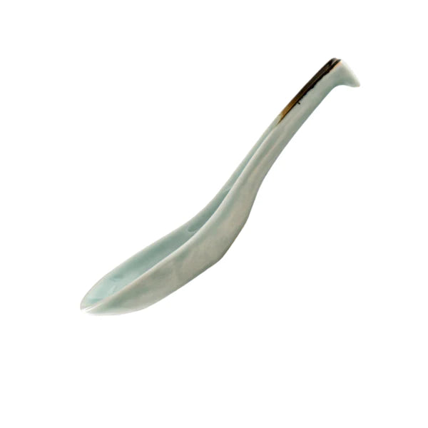 White ceramic spoon with brown accent on a white background