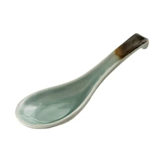 Light blue ceramic spoon on a white background