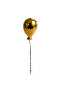 Gold balloon-shaped pull chain on a white background