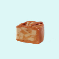small piece of apple pie pin with visible marbling on a light blue background