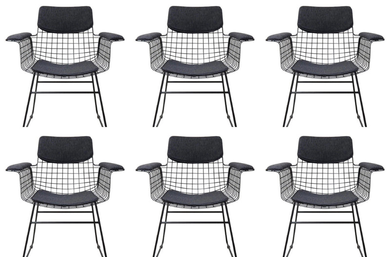 Six black wireframe chairs with black cushioned seats on a white background