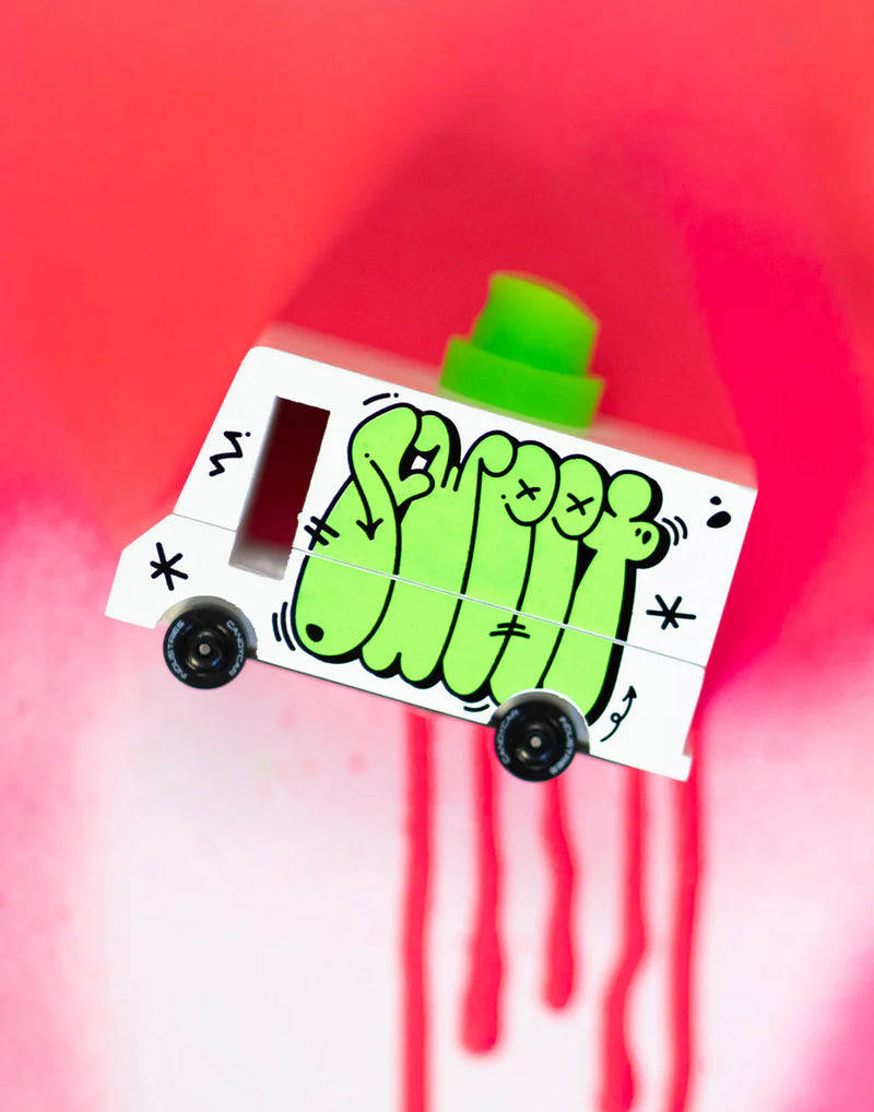 Toy car with green cartoonish face on a pink and red gradient background