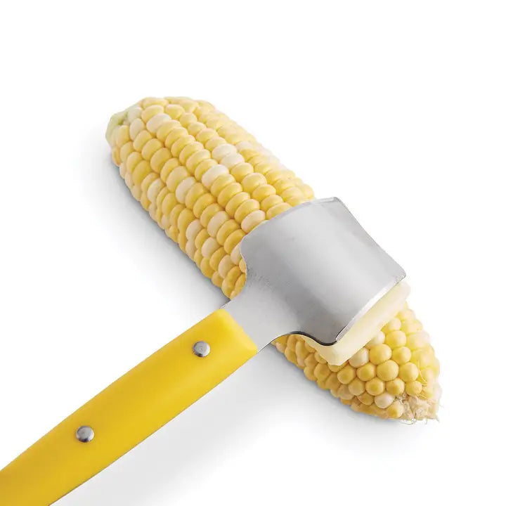 Corn on the cob with a  butter knife yellow handle and silver top on a white background