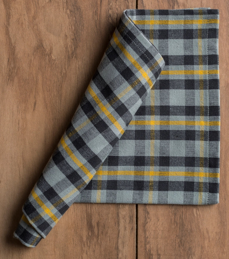 Plaid fabric roll on a wooden surface