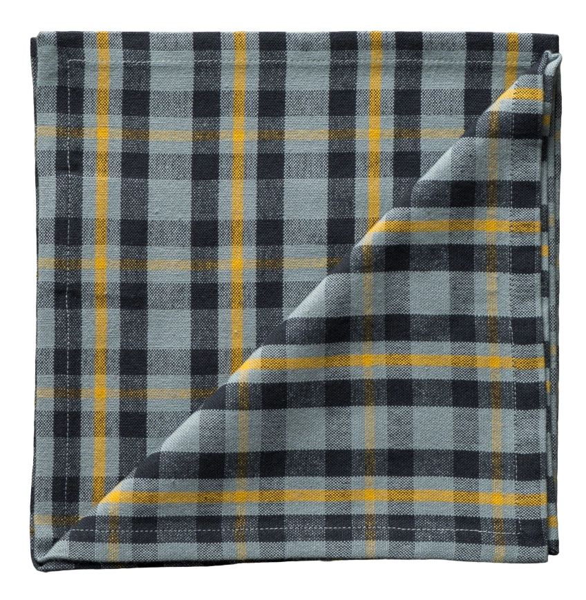 Folded plaid fabric with black, yellow, and gray colors on a neutral background