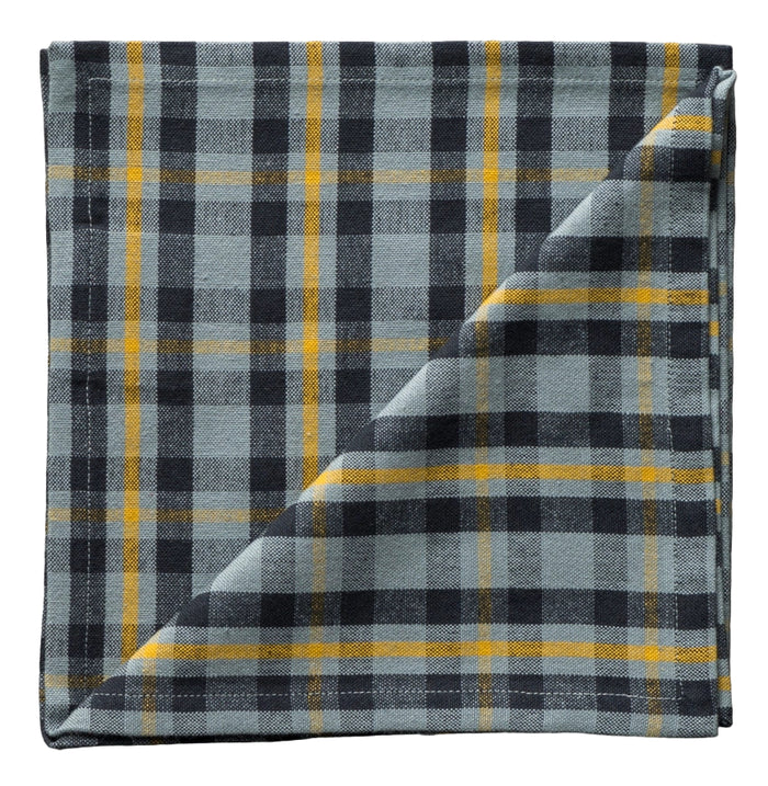 Folded plaid fabric with black, yellow, and gray colors on a neutral background