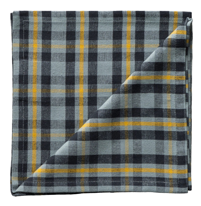 Folded plaid fabric with black, yellow, and gray colors on a neutral background