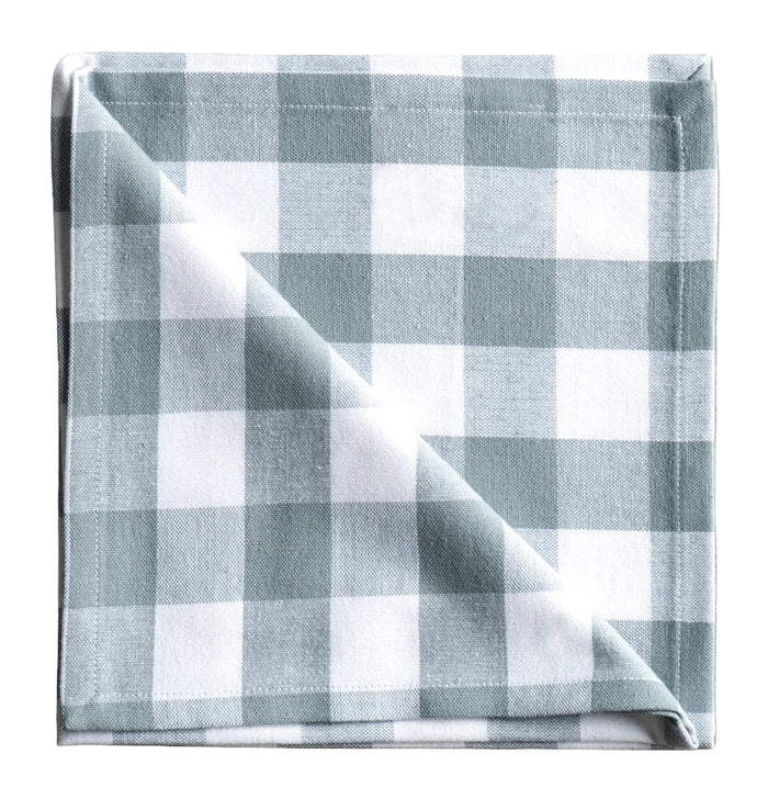 Folded checkered fabric napkin on a neutral background