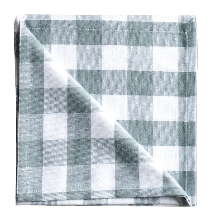 Folded checkered fabric napkin on a neutral background