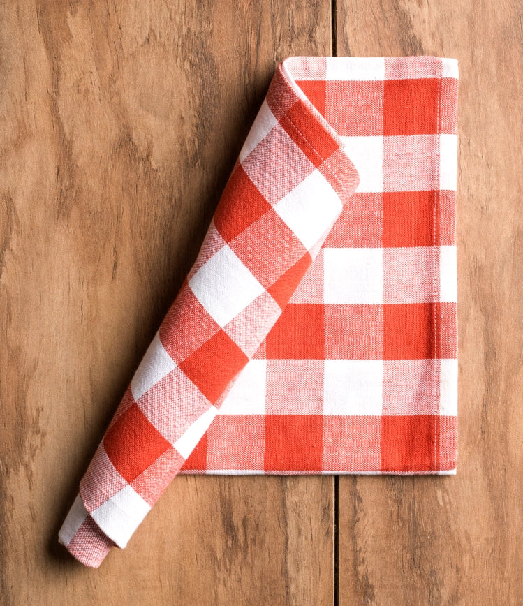 Red and white checkered towel on a wooden surface