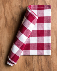 Red and white checkered towel on a wooden surface