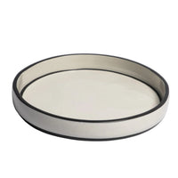 Round ceramic dish with black rim on a light gray background