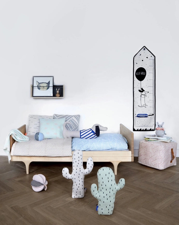 Children's room with a wooden bed, plush toys, and decorative items.