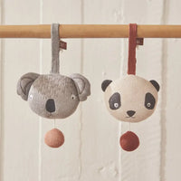 koala and panda shaped music mobile knitted figures on white back ground