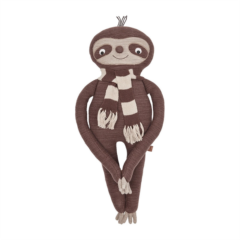 Knitted sloth toy with a checkered scarf on a white background