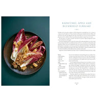 Plated dish of radicchio, apple, and buckwheat furikake on a dark plate with text on a teal background