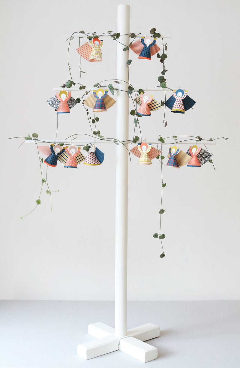 Decorative stand with hanging angel figures and lights on a white background