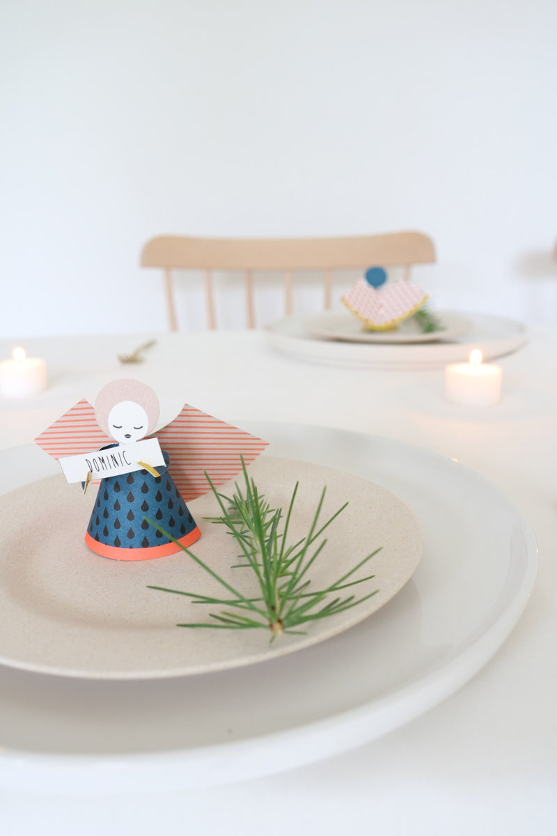 Decorative angel figurine on a plate with a white background