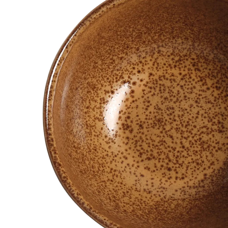 Brown ceramic plate with reactive glaze on a white background