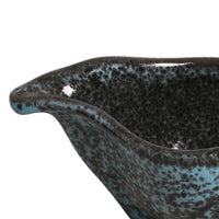 Ceramic bowl with reactive glaze on a white background