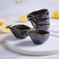 Set of ceramic bowls with a glossy finish on a white surface.