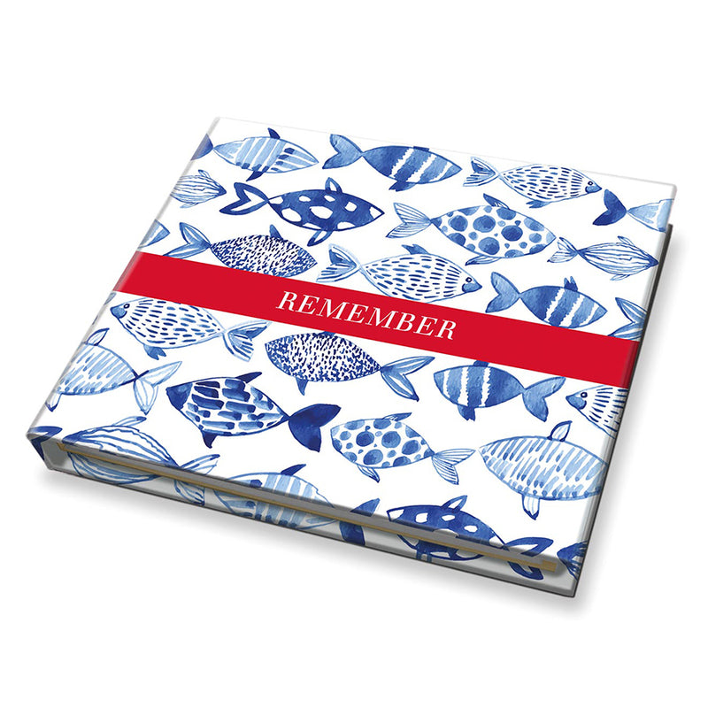 Notebook with blue fish pattern and red band on a white background