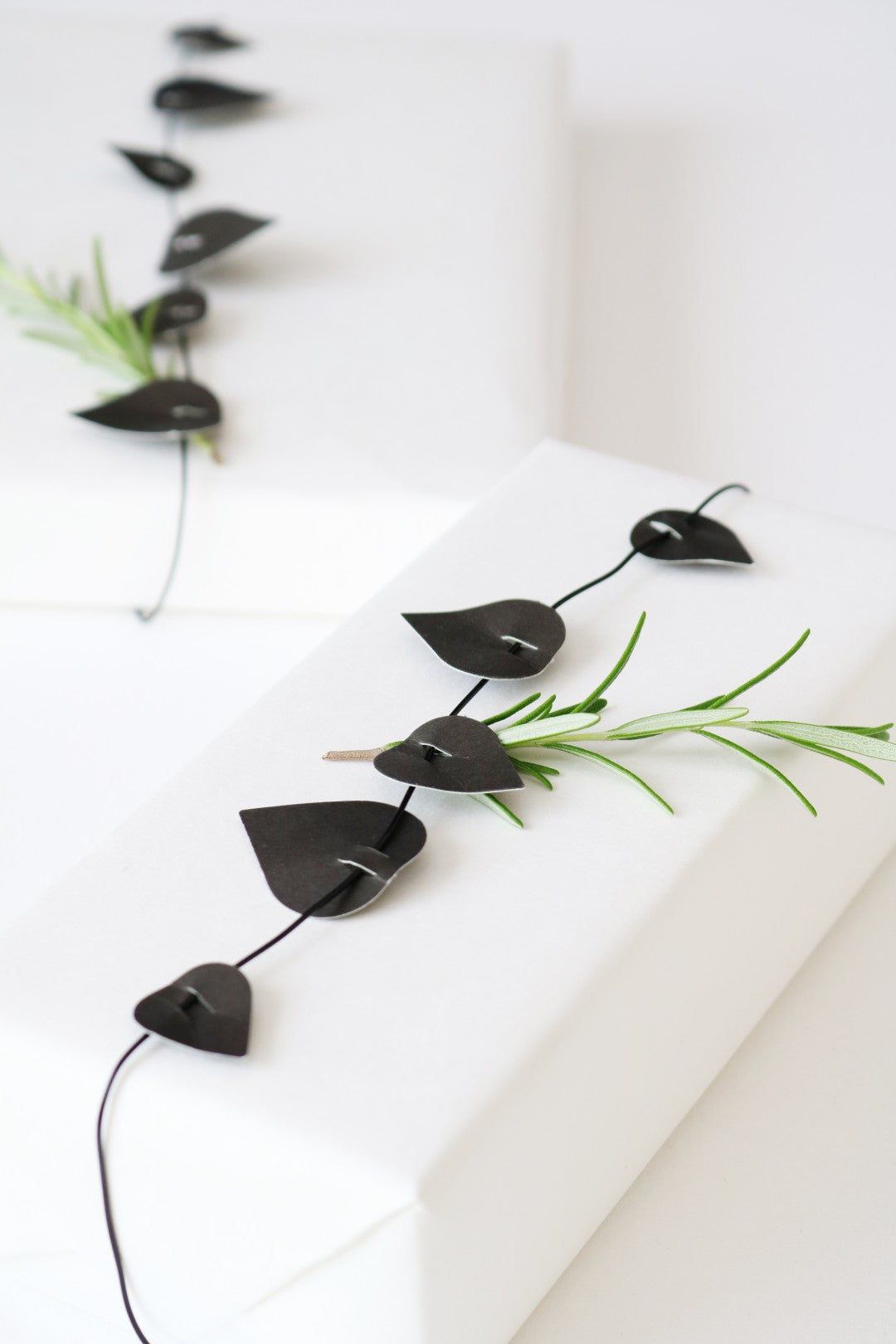 Decorative black leaf-shaped ornament on a white background