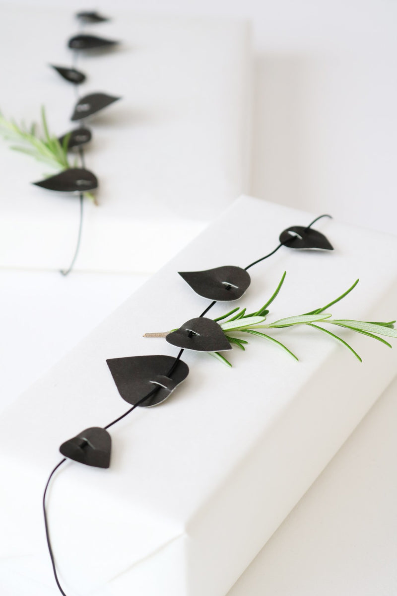 Decorative black leaf-shaped ornament on a white background