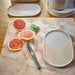 marble cuttting board with peach and yellow oval side plate