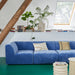 royal blue velvet sofa with cream colored earthenware planter and plants