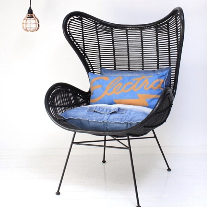 copper pendant light and black rattan egg chair with blue denim cushions