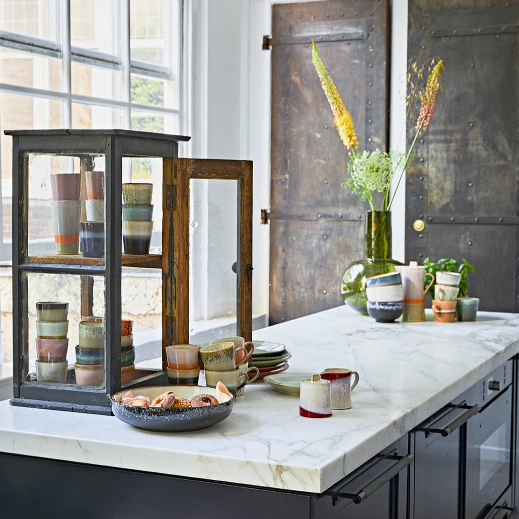 kitchen with marble counter top and milk jug and sugar pot in 70's style