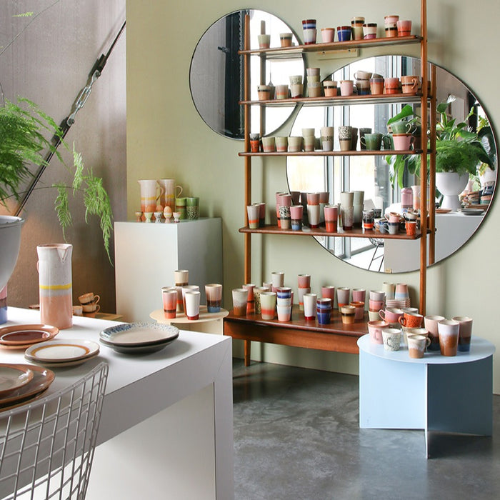 collection of 70's ceramics in open shelving display