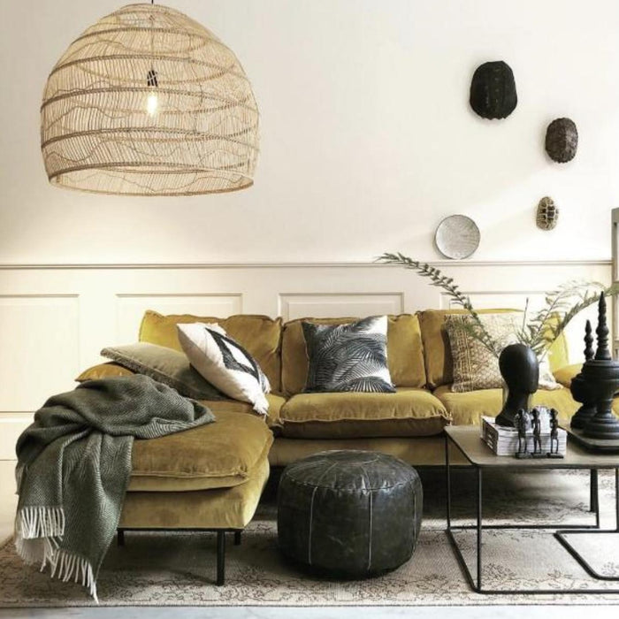 Large wicker pendant lamp in living room with sofa