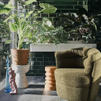 terrazzo side table with large planter on top of it