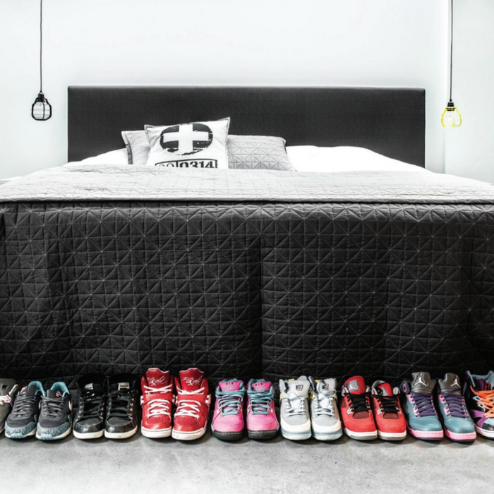 sneakers in bedroom with two pendant lab lights on each side of the bed