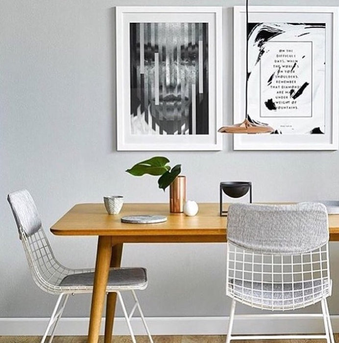 White metal dining chair with grey comfort kit and art works