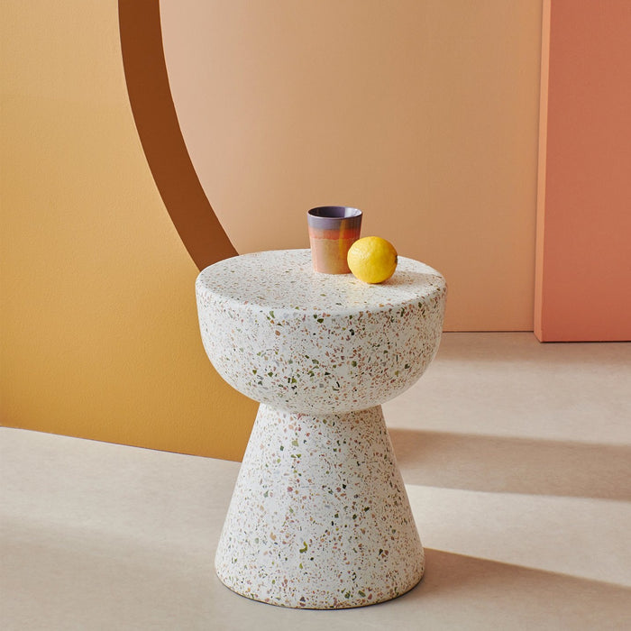 terrazzo side table with pastel colored coffee mug and lemon