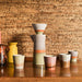 ceramic coffee filter and pot and mugs on wooden table
