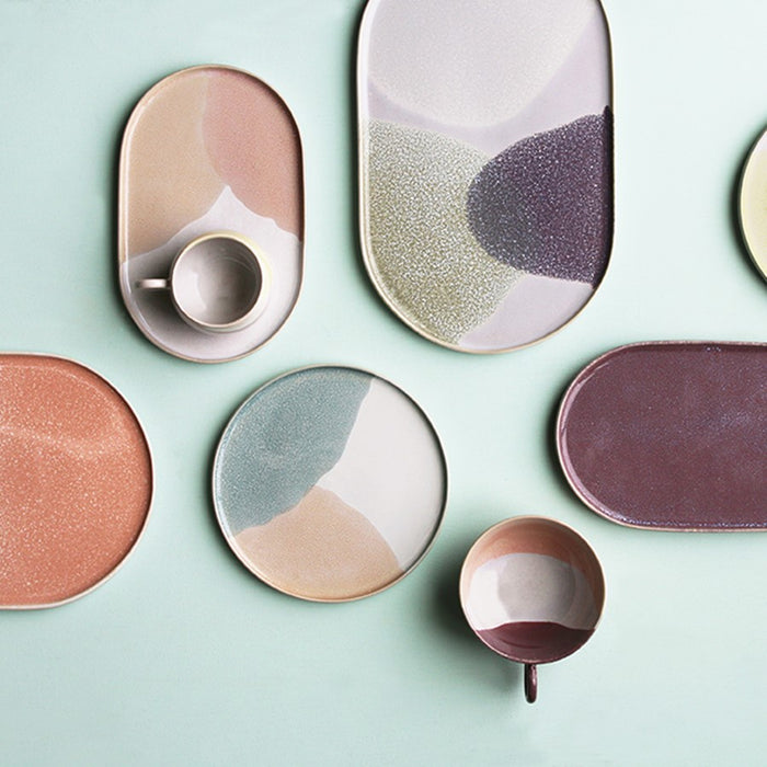 composition of oval and round dinner plates in pastel colors