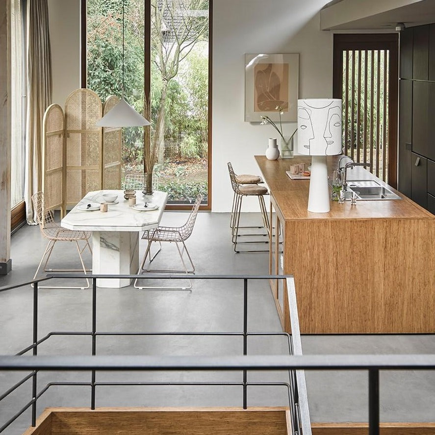 kitchen island with brass metal counter stools and camel colored felt seat protectors