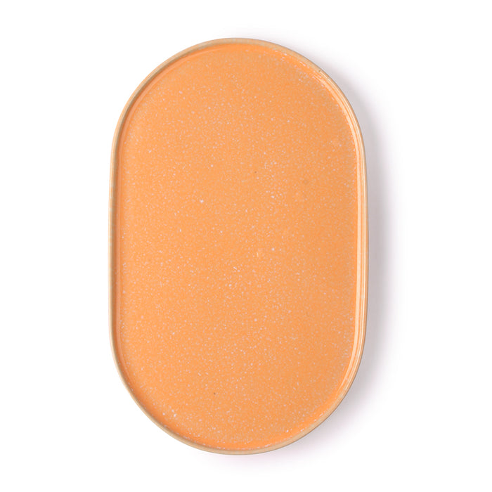 peach colored oval shaped side plate