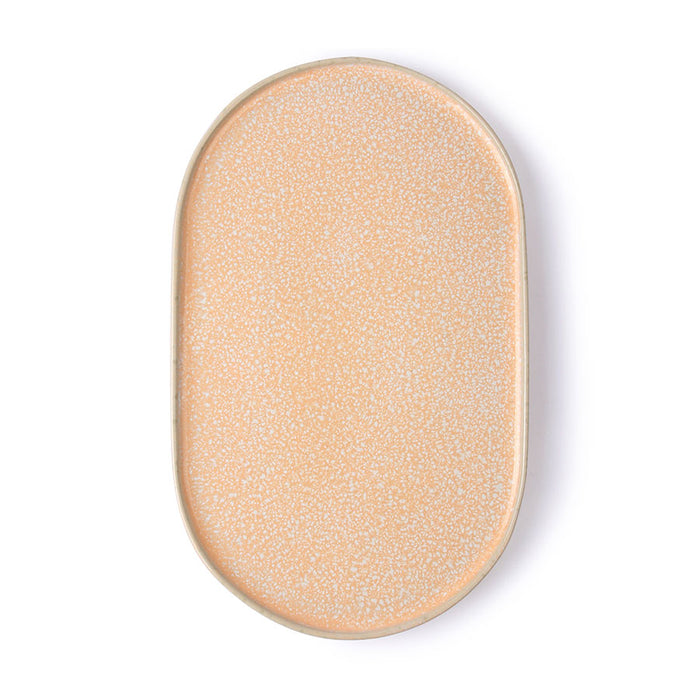 peach colored oval shaped side plate