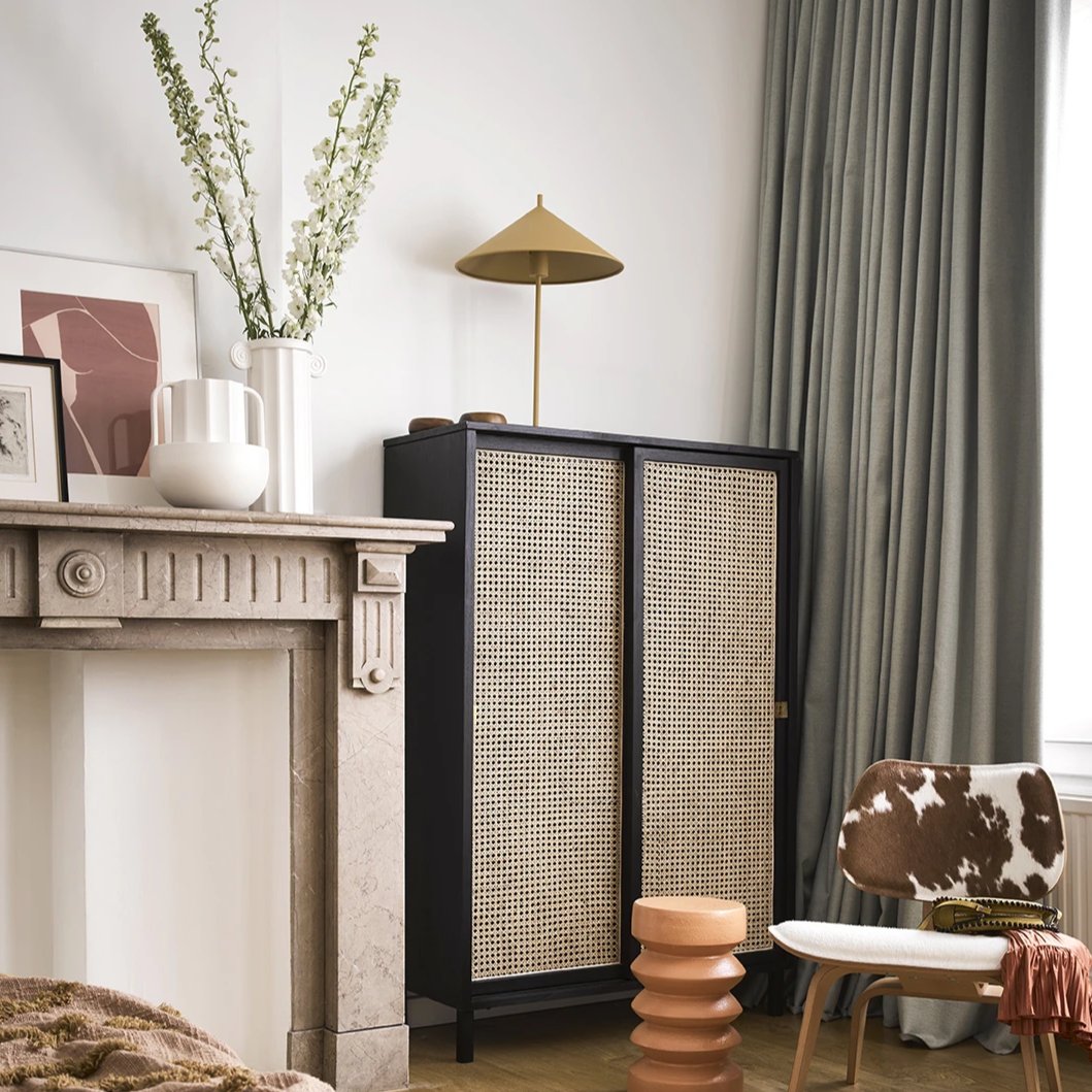 mid century modern living room with black cane sliding door cabinet and white greek inspired greek column vase by HK living USA