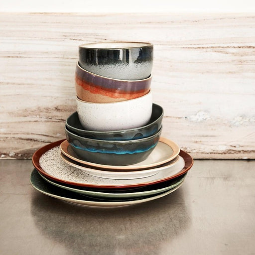 stack of ceramic bowls and plates in pastel colors