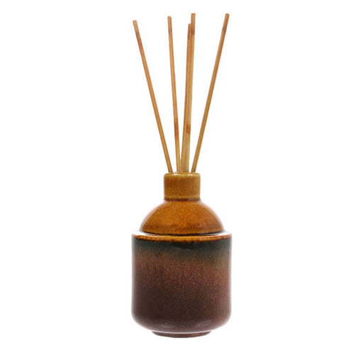 ochre yellow ceramic pot with wooden sticks for home fragrance