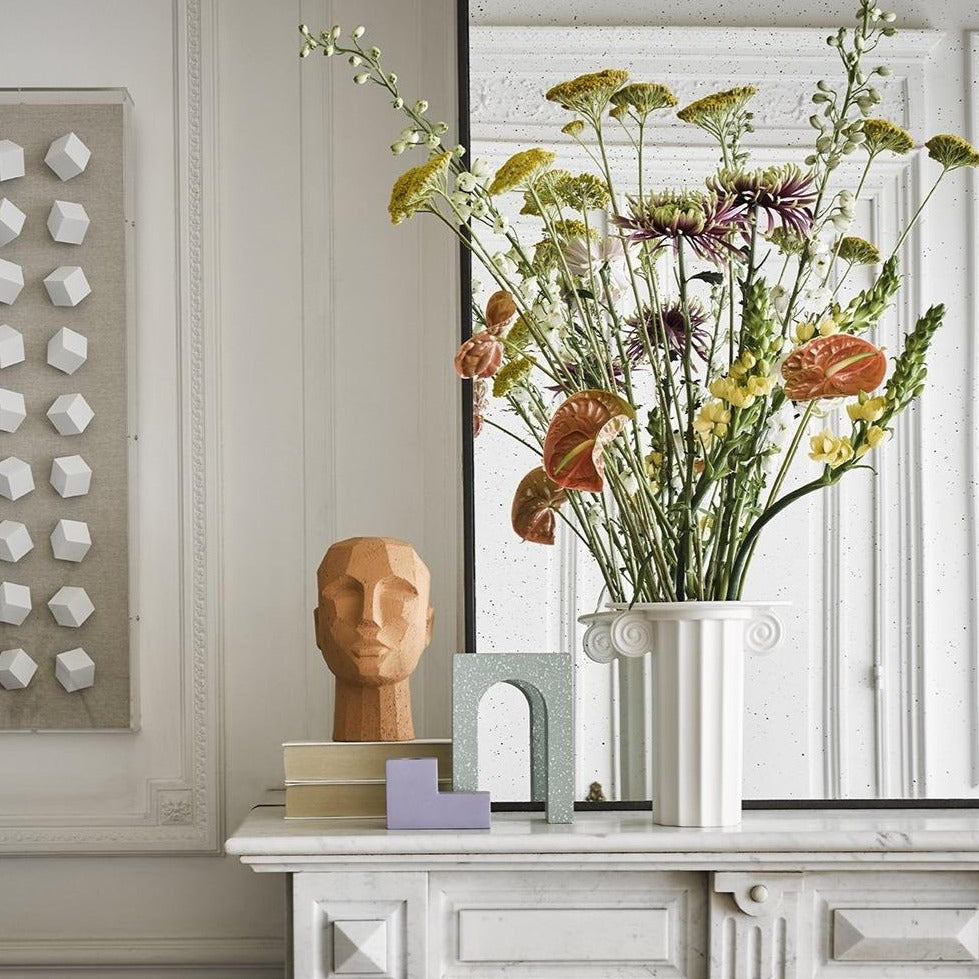 abstract head sculpture in terracotta on fire place mantel