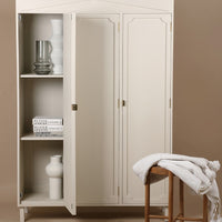 white cabinet with glass and ceramic vases