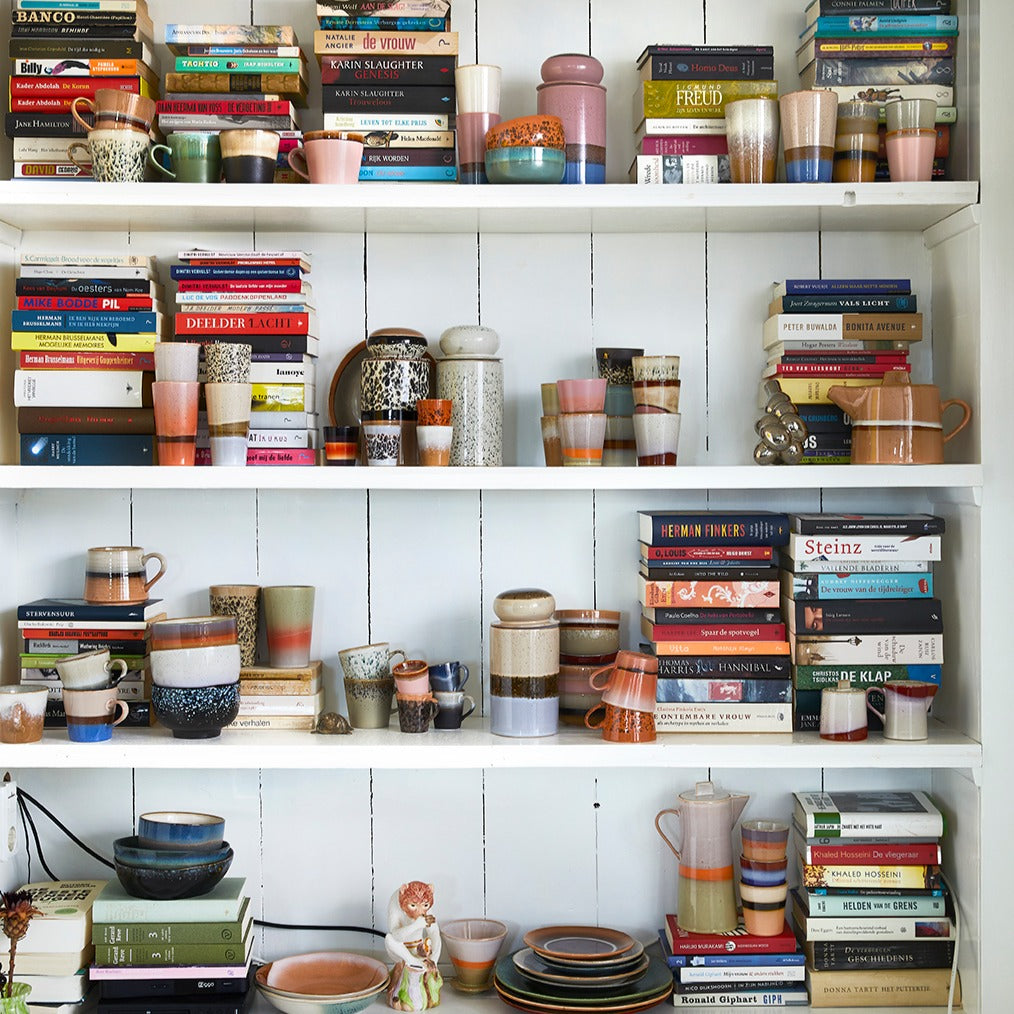 white, wooden open shelving filled with a combination of books and ceramics by HKliving