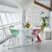 dining room with white pendant light, white walls, white lobby bench and a red chair for a pop of color
